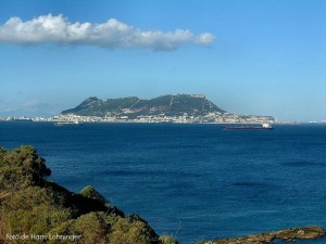 a body of water with a mountain in the background